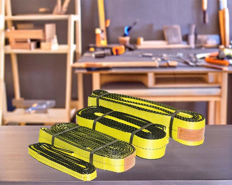 High-strength yellow synthetic slings on a workbench, designed for heavy-duty lifting and rigging applications
